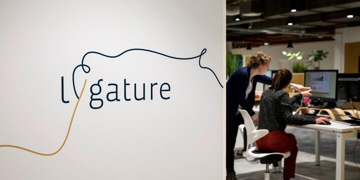 Logo and people sitting at a desk